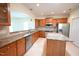 Well-lit kitchen featuring stainless steel appliances, granite countertops, and a functional island at 113 Dowington Ln, Cary, NC 27519