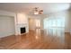 Open living room boasts hardwood floors, fireplace and a ceiling fan, perfect for relaxation at 113 Dowington Ln, Cary, NC 27519