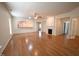 Spacious living room with hardwood floors, a fireplace, and bar access to the kitchen at 113 Dowington Ln, Cary, NC 27519