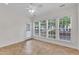 Bright sunroom with tile flooring and large windows, offering natural light and backyard views at 113 Dowington Ln, Cary, NC 27519