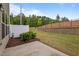 Private backyard featuring a concrete patio, partial fence, and lush green space, perfect for outdoor activities at 1136 Longitude Dr, Durham, NC 27713