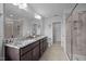 Spacious bathroom with double sink vanity, granite countertop, and glass door shower at 1136 Longitude Dr, Durham, NC 27713