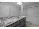 Bright bathroom with granite countertops, dual sinks, and modern fixtures at 1136 Longitude Dr, Durham, NC 27713