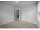 Bright bedroom features neutral walls, carpet, closet, and an open door that leads to another room at 1136 Longitude Dr, Durham, NC 27713