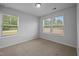 Bedroom featuring carpet, light walls, and two windows at 1136 Longitude Dr, Durham, NC 27713