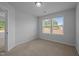 Bedroom featuring large window and neutral carpet at 1136 Longitude Dr, Durham, NC 27713
