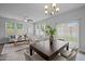 Dining room area features hardwood floors, large window for light, seating for six and modern lighting at 1136 Longitude Dr, Durham, NC 27713