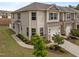 Two-story townhome features a one-car garage, neutral siding, manicured landscaping, and a concrete drive at 1136 Longitude Dr, Durham, NC 27713