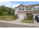 Two-story townhome showcasing a well-manicured lawn, an attached garage, and neutral-colored siding at 1136 Longitude Dr, Durham, NC 27713