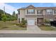 Inviting townhome with a one-car garage, neutral siding, and manicured front yard landscaping at 1136 Longitude Dr, Durham, NC 27713