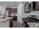 The kitchen showcases modern appliances, granite countertops, subway tile backsplash, and dark wood cabinets at 1136 Longitude Dr, Durham, NC 27713