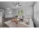 Living room area features hardwood floors, natural light, modern ceiling fan and comfortable seating at 1136 Longitude Dr, Durham, NC 27713