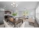 Open concept living space with dining room, kitchen, hardwood floors, modern furniture and lots of light at 1136 Longitude Dr, Durham, NC 27713