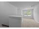 Open loft area with neutral carpeting, bright windows, and a view of the outdoors at 1136 Longitude Dr, Durham, NC 27713