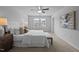 Bright main bedroom with neutral tones, large window, ceiling fan and carpet floors at 1136 Longitude Dr, Durham, NC 27713