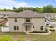 Rear view of a two-story townhome with neutral siding, well-maintained landscaping, and a private entrance at 1136 Longitude Dr, Durham, NC 27713