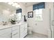 Elegant bathroom featuring double sinks, white cabinetry, and a glass-enclosed shower at 1202 Bradburn Dr, Durham, NC 27713
