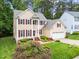 Aerial view of a two-story tan home with a two car garage and green yard at 12325 Amoretto Way, Raleigh, NC 27613
