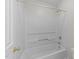Clean, bright bathtub and shower combo features white surround and updated fixtures at 12325 Amoretto Way, Raleigh, NC 27613