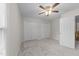Neutral bedroom features soft carpet, a ceiling fan, and double door closets at 12325 Amoretto Way, Raleigh, NC 27613