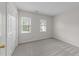 Bedroom with neutral carpet, two windows and closet; ready for your personal touch at 12325 Amoretto Way, Raleigh, NC 27613