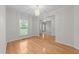 Dining room featuring hardwood floors, chandelier lighting, and open access to adjoining living areas at 12325 Amoretto Way, Raleigh, NC 27613