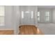 Inviting entryway with hardwood floors, white trim, and a view into the adjacent living spaces at 12325 Amoretto Way, Raleigh, NC 27613