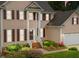 Charming two-story home with a landscaped front yard, inviting entrance, and attached garage at 12325 Amoretto Way, Raleigh, NC 27613