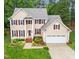 Attractive two-story home with landscaped front yard, driveway, attached garage, and inviting entryway at 12325 Amoretto Way, Raleigh, NC 27613
