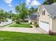 Well-manicured front lawn with a two-car garage on a sunny day at 12325 Amoretto Way, Raleigh, NC 27613