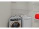 Bright laundry room with washer, dryer, and convenient wire shelving for storage at 12325 Amoretto Way, Raleigh, NC 27613