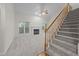 Bright living room featuring fireplace, carpet, ample windows, and staircase at 12325 Amoretto Way, Raleigh, NC 27613