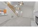 Spacious living room featuring stairway, fireplace, and view of the kitchen at 12325 Amoretto Way, Raleigh, NC 27613