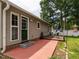 Inviting backyard patio with dining set, shed, white fence, and well-maintained lawn at 1290 Pyrtle Dr, Graham, NC 27253