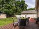 Charming backyard deck with outdoor seating, white fence, lush landscaping, and a storage shed at 1290 Pyrtle Dr, Graham, NC 27253