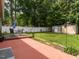 Landscaped backyard with a patio, dining set, garden shed, and lush greenery at 1290 Pyrtle Dr, Graham, NC 27253