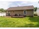 Home backyard featuring a deck and outdoor dining set for entertaining and relaxing at 1290 Pyrtle Dr, Graham, NC 27253
