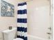 Bathroom featuring a blue-striped shower curtain and octopus wall art at 1290 Pyrtle Dr, Graham, NC 27253