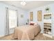 Serene bedroom featuring a cozy bed, soft lighting, and a view of the lush outdoor scenery at 1290 Pyrtle Dr, Graham, NC 27253