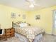 Comfortable bedroom with soft yellow walls, cozy bedding, and a ceiling fan for added comfort at 1290 Pyrtle Dr, Graham, NC 27253