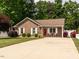 Charming brick home with a well-manicured lawn and inviting front porch at 1290 Pyrtle Dr, Graham, NC 27253