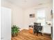 Bright office space with wood floors, natural light, and a storage cabinet at 1290 Pyrtle Dr, Graham, NC 27253