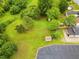 Aerial view of a property featuring lush greenery and mature trees and a shed at 1309 Jackson St, Burlington, NC 27217