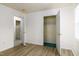 Bright bedroom with a closet and views to the next room with wood look flooring and neutral paint at 1309 Jackson St, Burlington, NC 27217