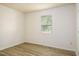 A bright bedroom with a window, wood look flooring, and neutral paint throughout at 1309 Jackson St, Burlington, NC 27217