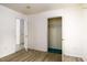 Bedroom with closets, wood look flooring, and views to the next room with tile at 1309 Jackson St, Burlington, NC 27217