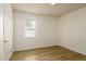 Bedroom featuring wood look flooring, light colored walls, and a window with blinds at 1309 Jackson St, Burlington, NC 27217