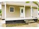 Inviting covered front porch with classic white columns and steps leading to the front door at 1309 Jackson St, Burlington, NC 27217