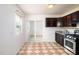 Efficient kitchen layout with stainless steel appliances, dark cabinets, tiled floors and a sliding door at 1309 Jackson St, Burlington, NC 27217