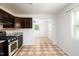 An eat-in kitchen featuring tiled floors, granite countertops, and stainless steel appliances at 1309 Jackson St, Burlington, NC 27217